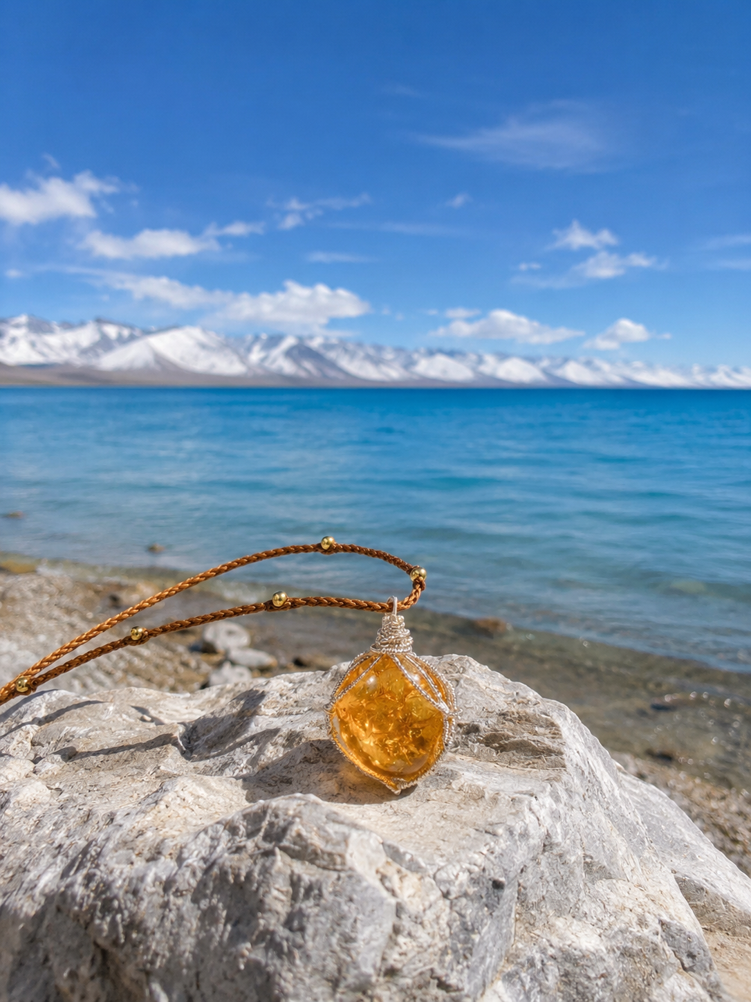 Natural citrine pendant displayed beside a Himalayan lake