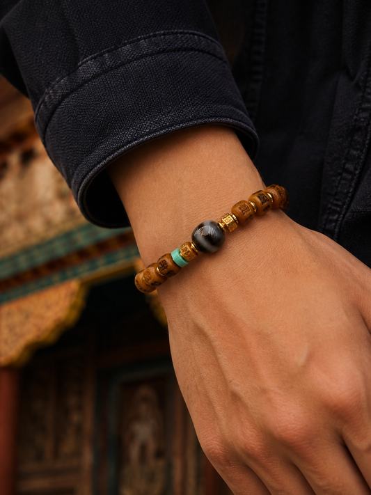 Tibetan Bone Mala Bracelet with Six-Syllable Motif — worn on wrist
