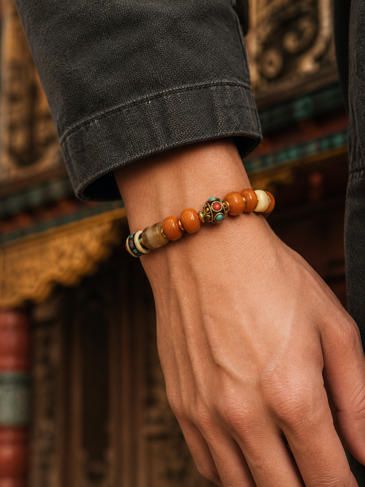 Tibetan Caramel-Toned Bone Mala Bracelet with Nepalese-Style Bead — worn on wrist