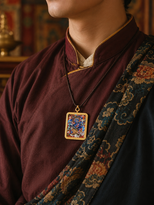 Mahakala thangka pendant worn on a dark cord over burgundy clothing