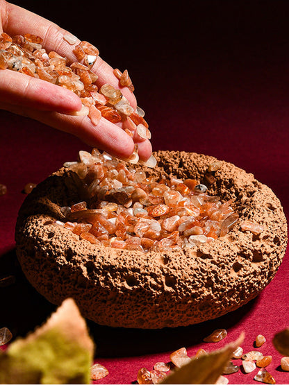 Orange cleansing bowl being filled with crystal chips
