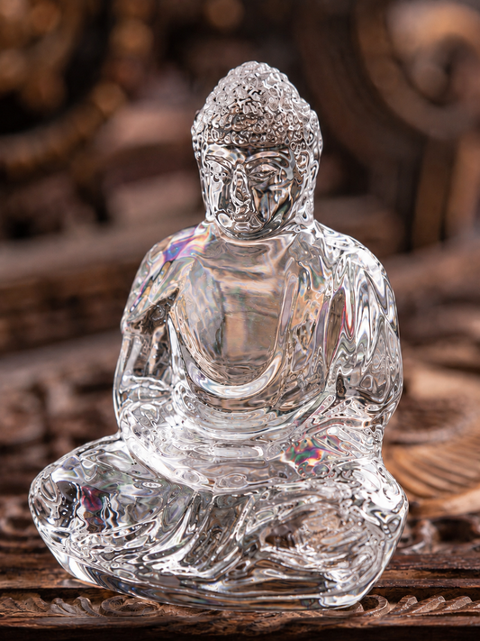 Close view of the clear crystal Tathagata statue's face, folded robes, and seated posture