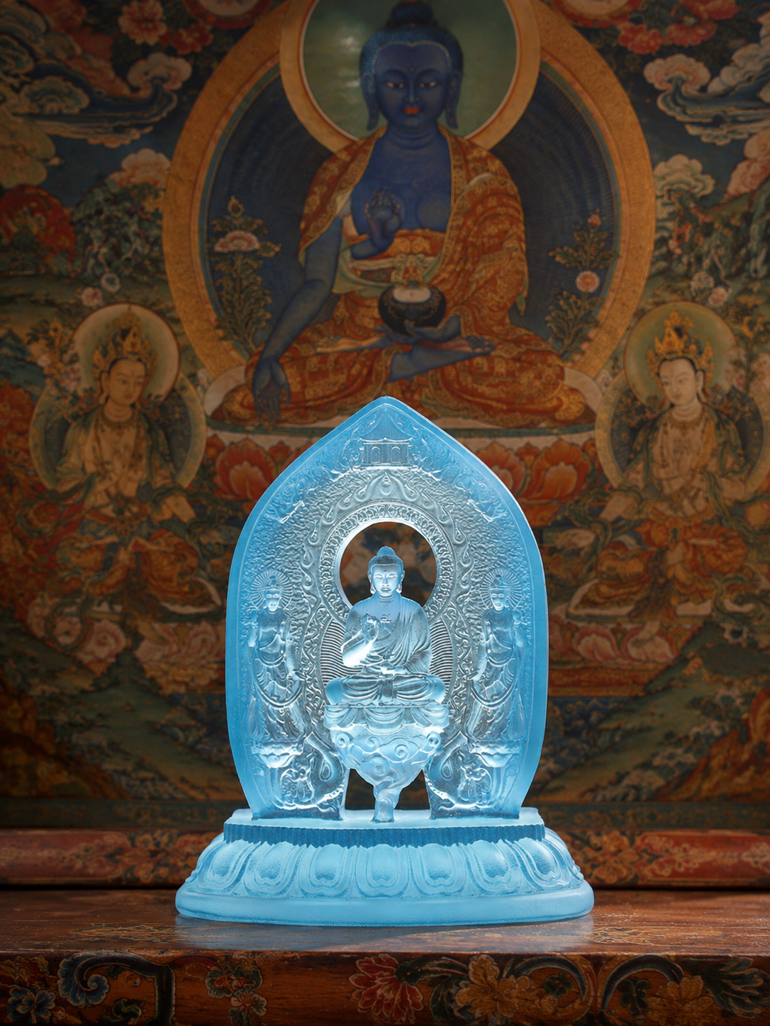 Plain Medicine Buddha triad statue before a thangka