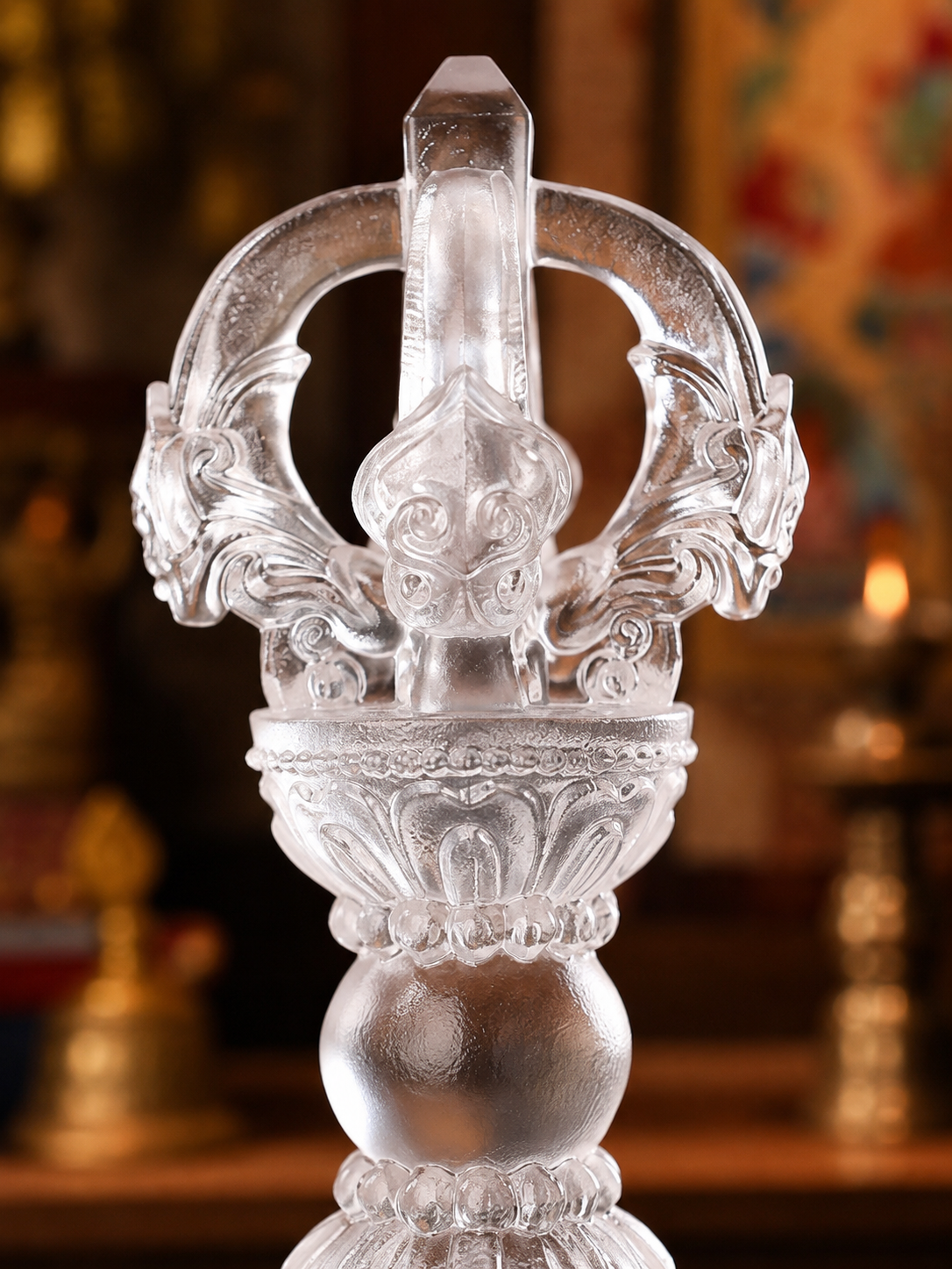 Close view of liuli glass vajra prongs and carved details