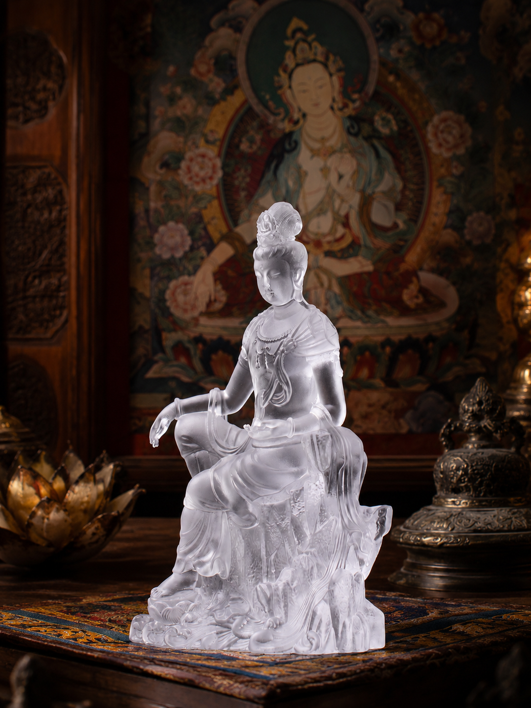 Clear Guanyin statue before a traditional painting