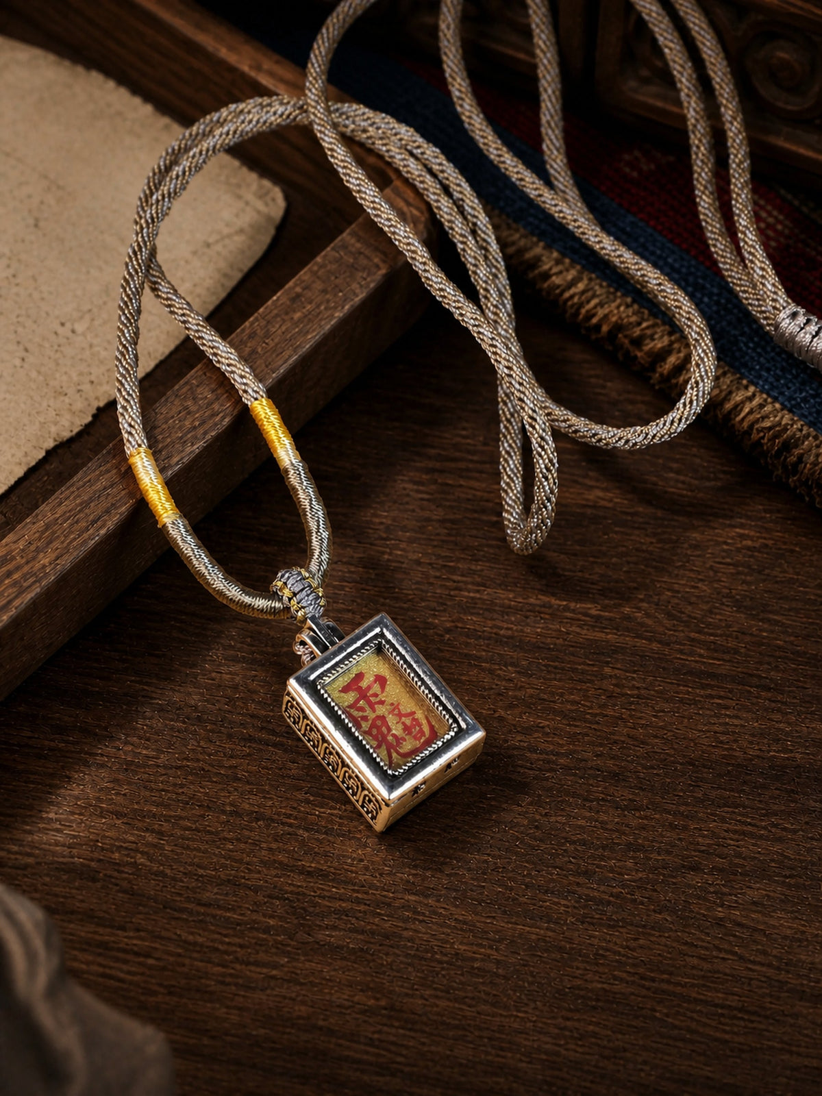 Tai Sui design mini thangka pendant: painted symbol on yellow, with a brown-and-cream braided cord
