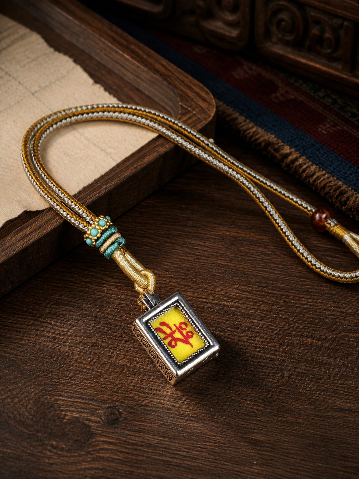 Maitreya Buddha design mini thangka pendant: painted symbol on yellow, with a gold-and-gray braided cord