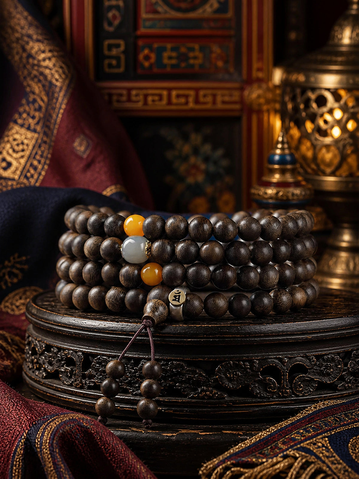 Tibetan 108-bead agarwood mala bracelet in an ornate Tibetan-inspired setting