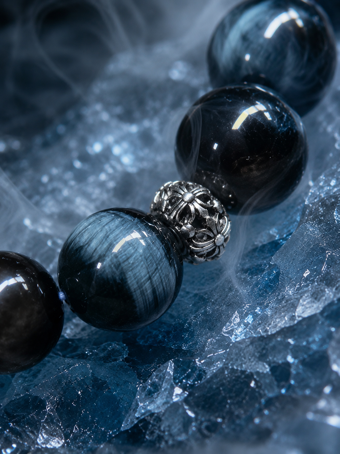 Close detail of blue tiger’s eye beads and Tibetan-style focal bead