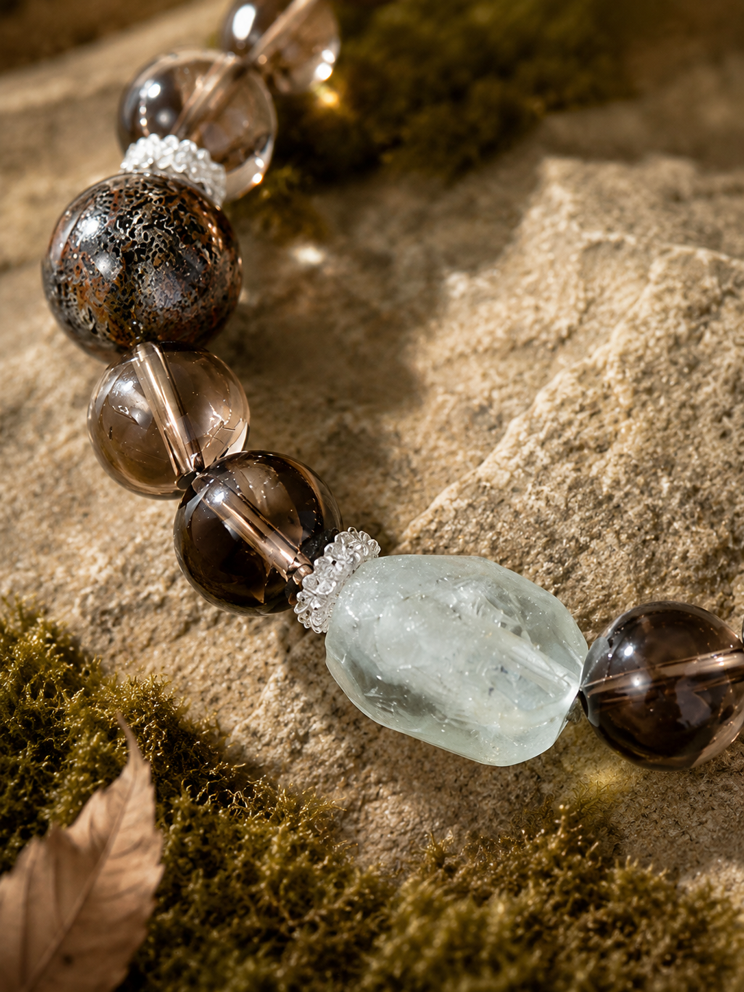 Detail of black-gold crystal beads and pale blue focal stone