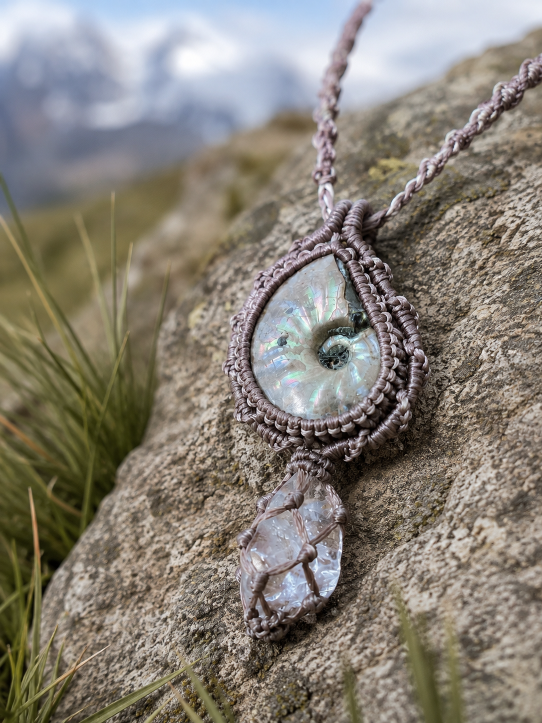 Close view of the spiral-pattern focal and clear stone drop in the gray woven necklace