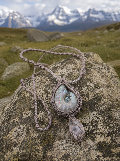 Full woven necklace displayed on mountain stone