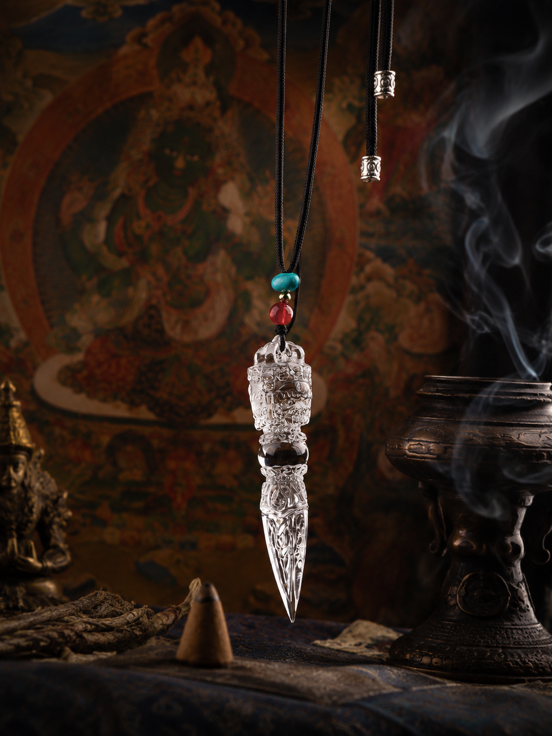 Clear quartz vajra amulet displayed indoors