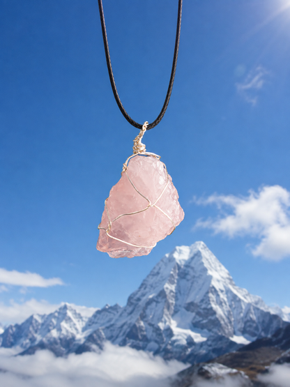 Close view of raw rose quartz pendant against the sky