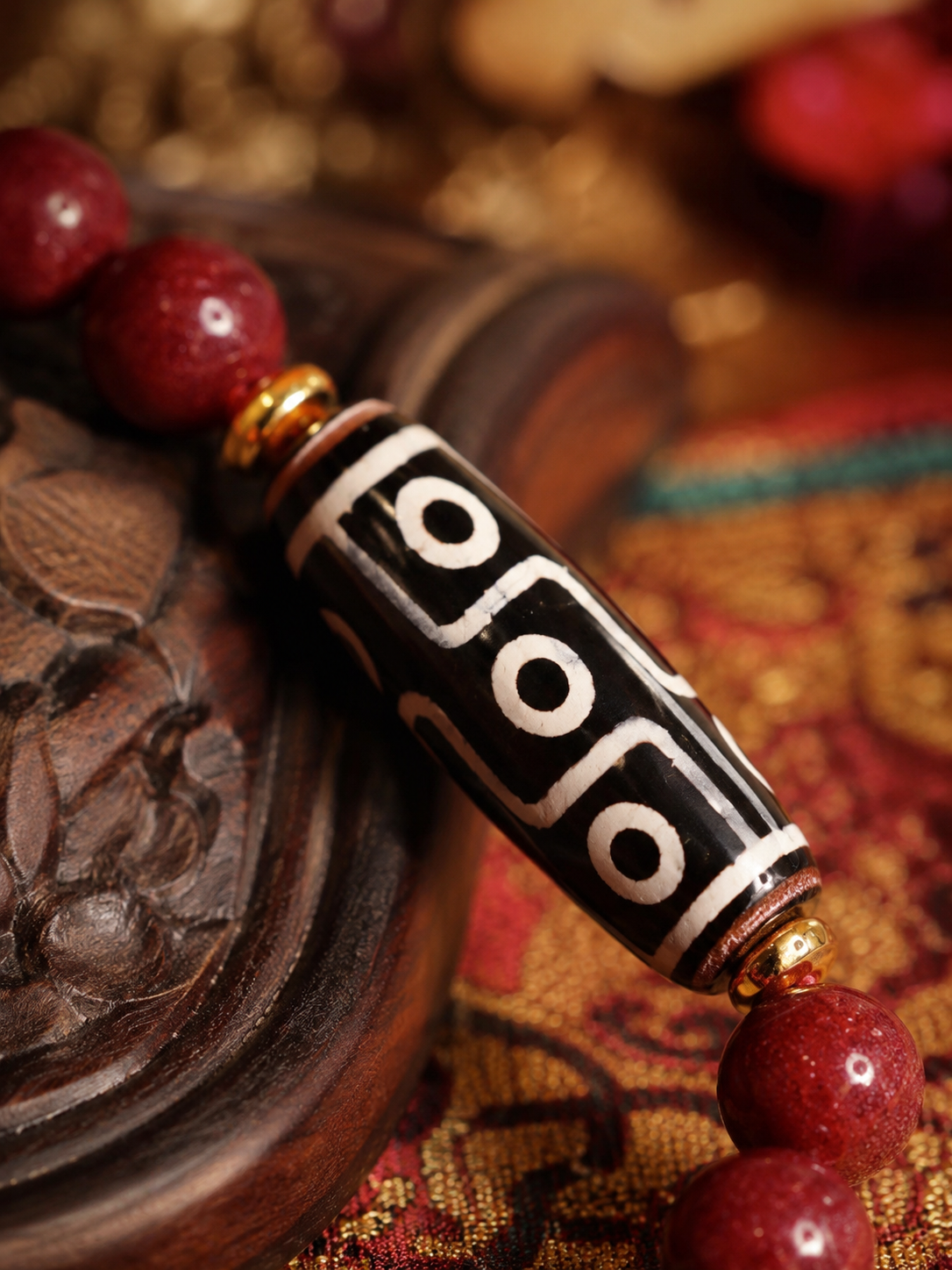 Tibetan Nine-Eye Dzi & Cinnabar Bracelet — detail view