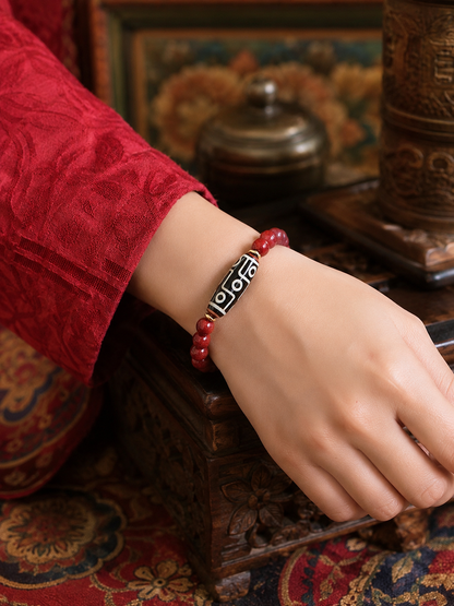 Tibetan Nine-Eye Dzi & Cinnabar Bracelet — wearing view