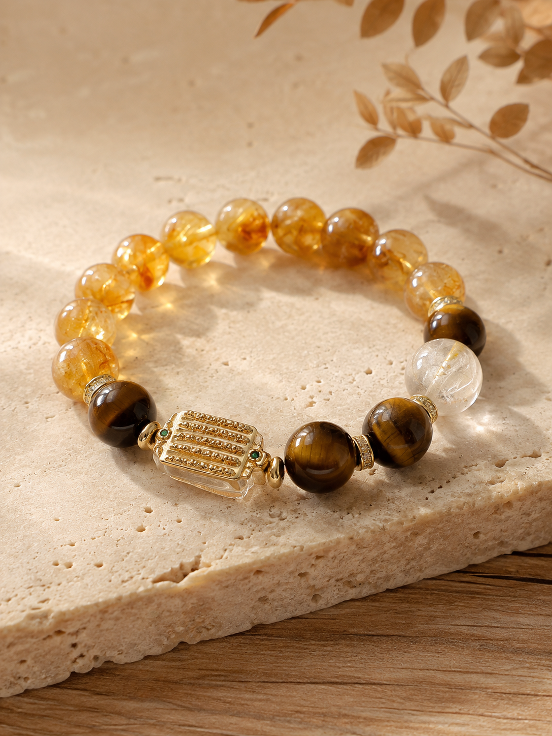 Full circle of the yellow crystal bracelet on pale stone, showing its decorative rectangular focal