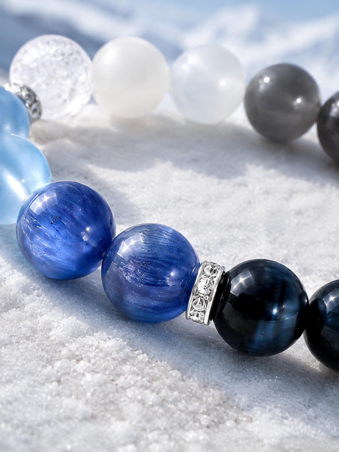 Close view of blue crystal bracelet beads and patterned silver-colored spacers