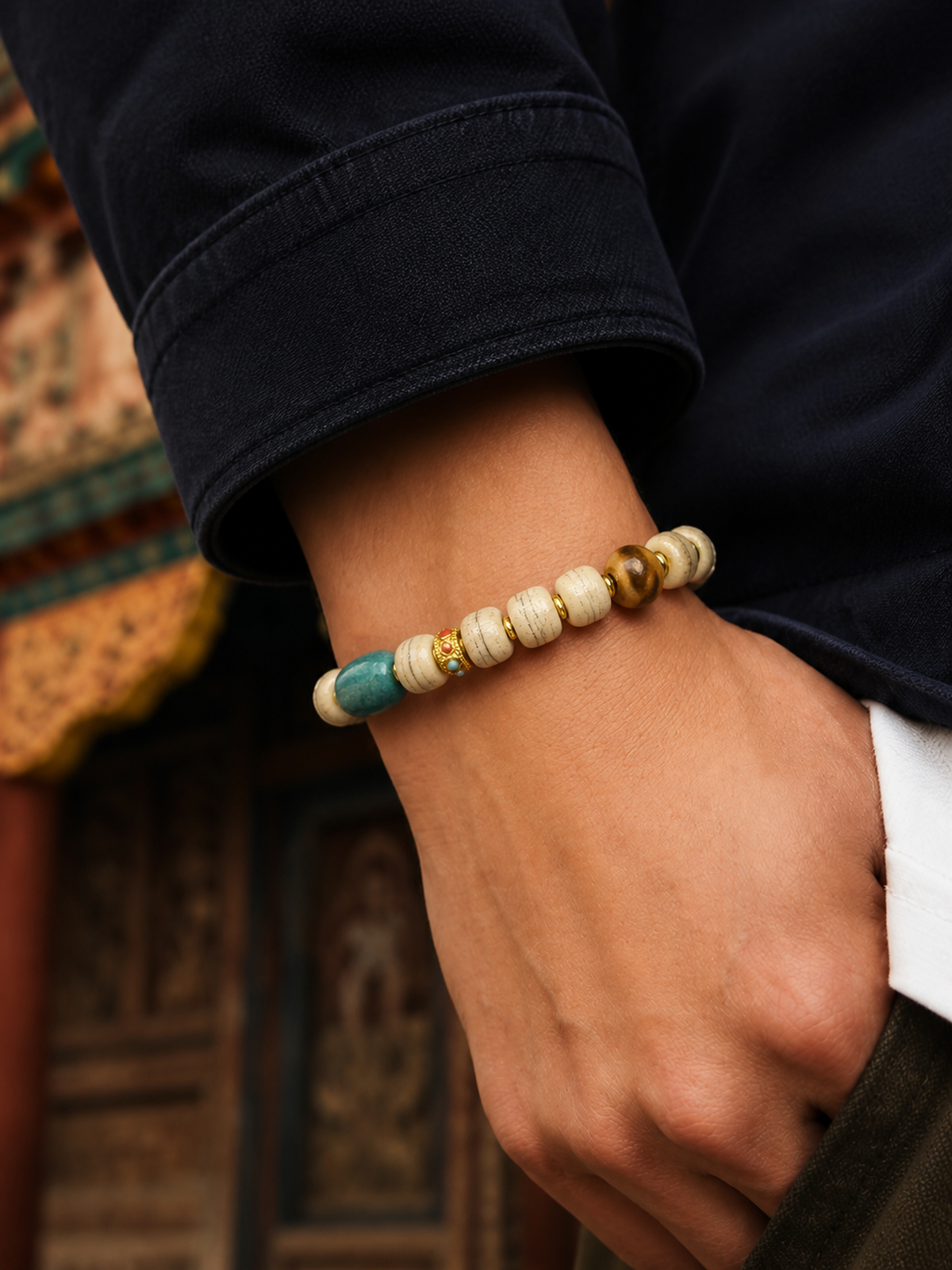 Tibetan Bone Mala Bracelet with Turquoise-Tone Accents — worn on wrist