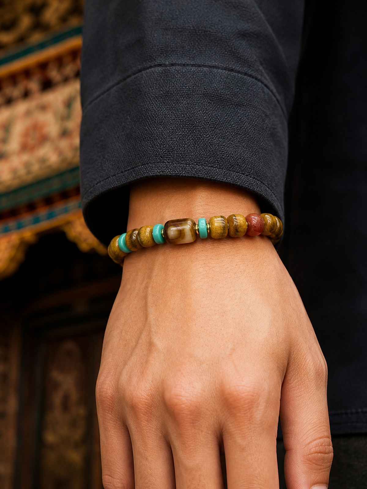 Tibetan Rose-Toned Bone Mala Bracelet with Dzi-Style Bead — worn on wrist