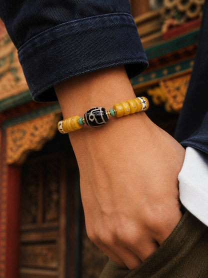 Tibetan Sliced Bone Mala Bracelet with Jambhala Dzi-Style Bead — worn on wrist