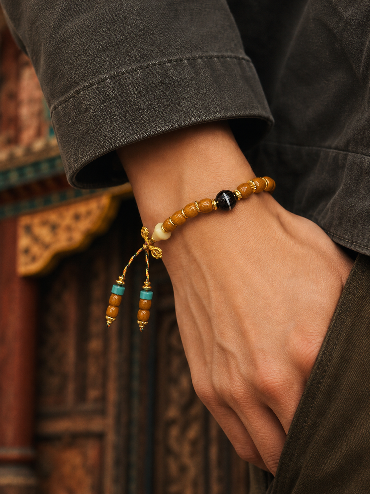 Tibetan Bone Mala Bracelet with Linear Pumpkin Beads — worn on wrist