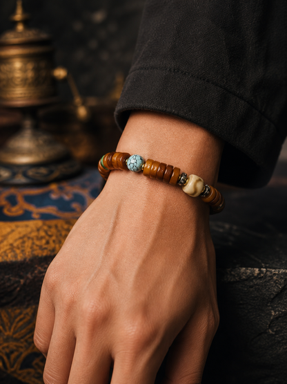 Tibetan Flat Bone Mala Bracelet with Tiger-Tooth and Turquoise-Tone Accents — worn on wrist