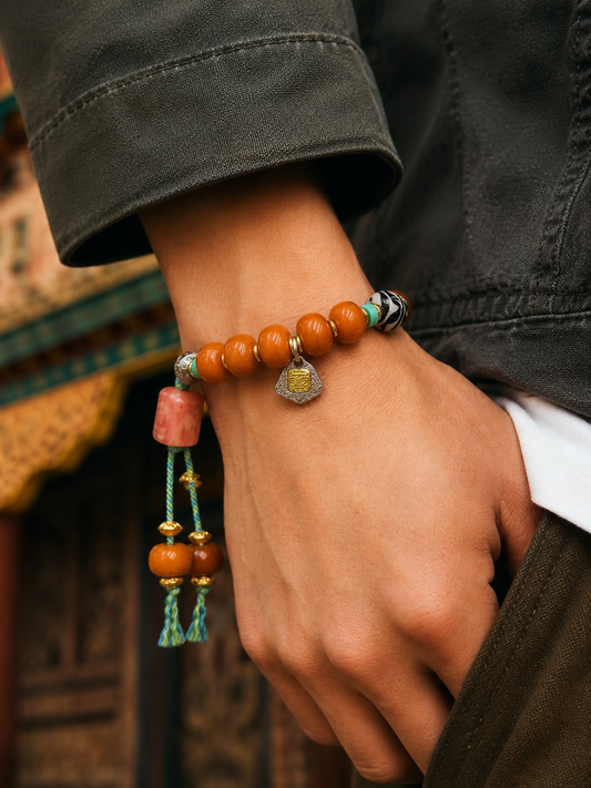 Tibetan Caramel-Toned Bone Mala Bracelet with Faceless Buddha Pendant — worn on wrist