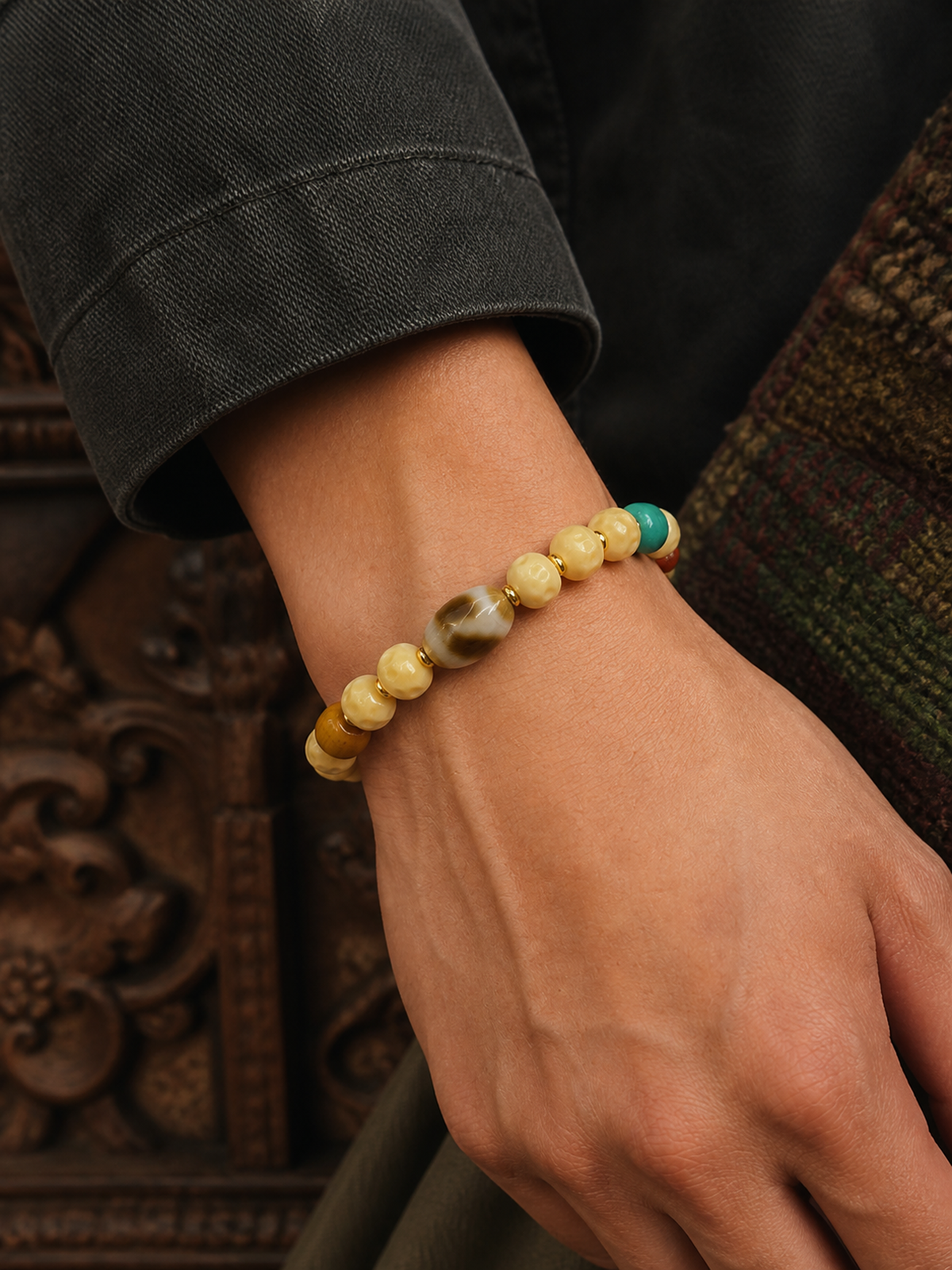 Tibetan Cream-Toned Bone Mala Bracelet with Faceless Buddha and Tiger-Tooth Beads — worn on wrist