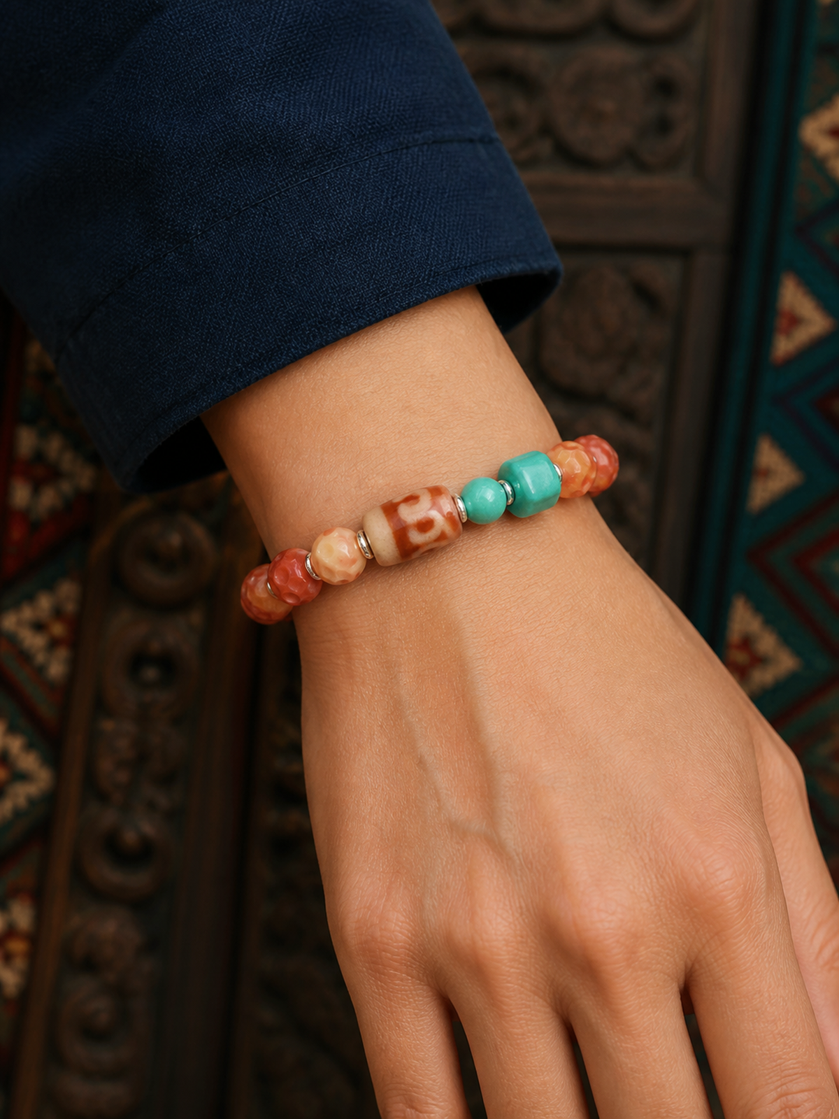 Tibetan Rose-Toned Bone Mala Bracelet with Red Three-Eye Bead — worn on wrist