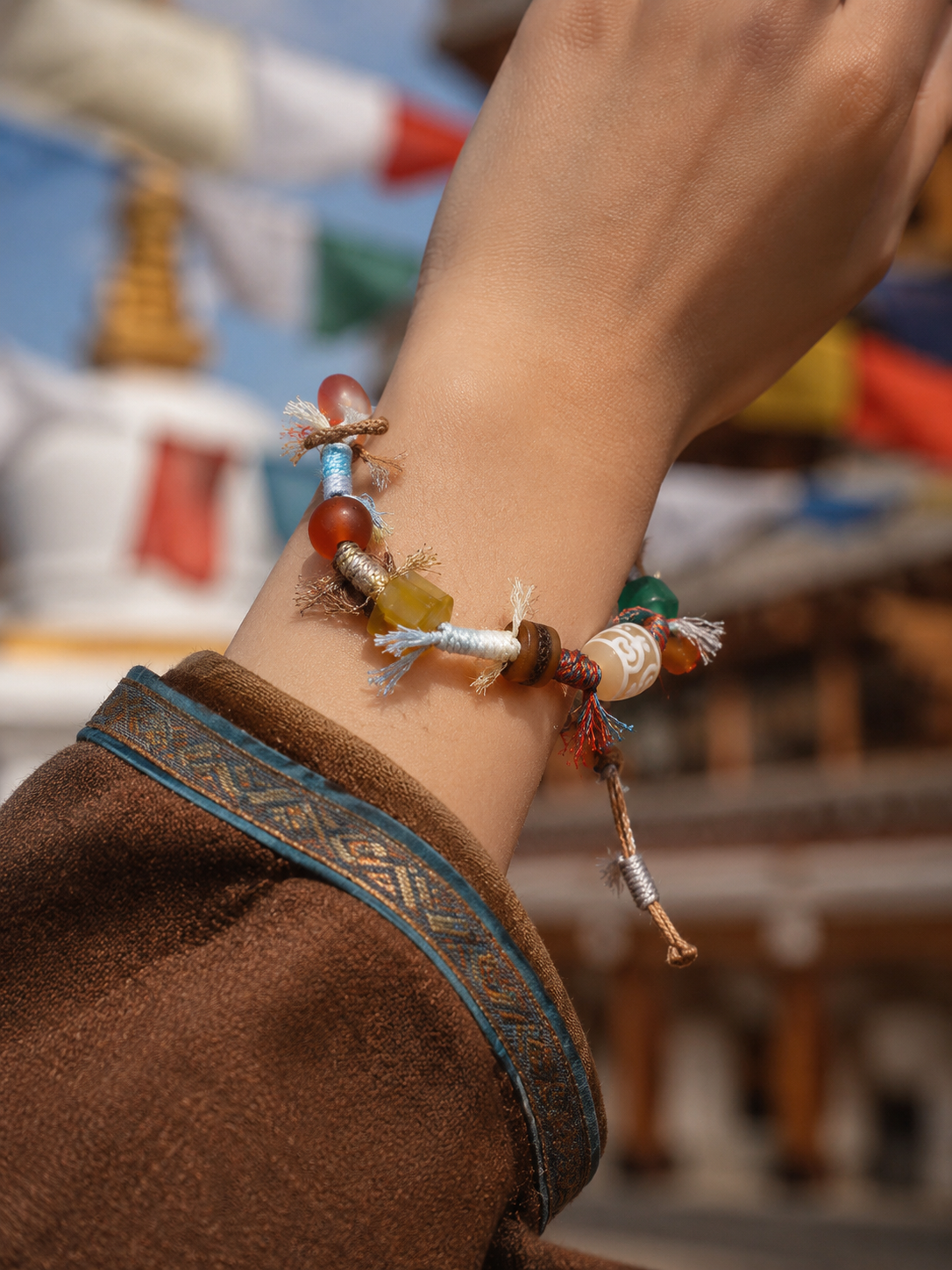 Tibetan treasure-vase Dzi-inspired handwoven cord bracelet worn on wrist