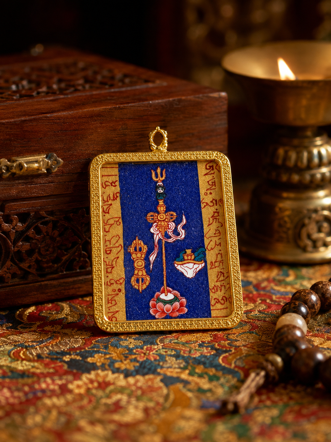 Padmasambhava Heart Mantra pendant with painted symbols on blue and a gold-colored border