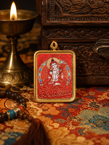 Mahasthamaprapta thangka pendant with a pale seated figure against a red ground