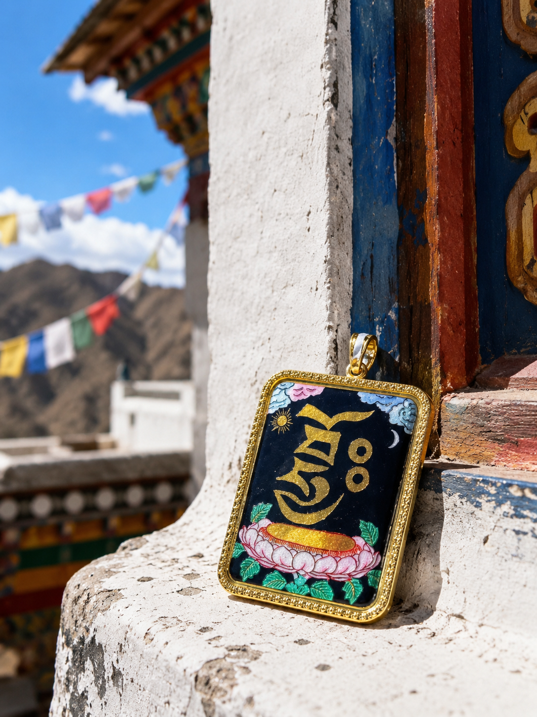 Zaki Lhamo Heart Mantra pendant displayed on a white ledge beside a painted window frame