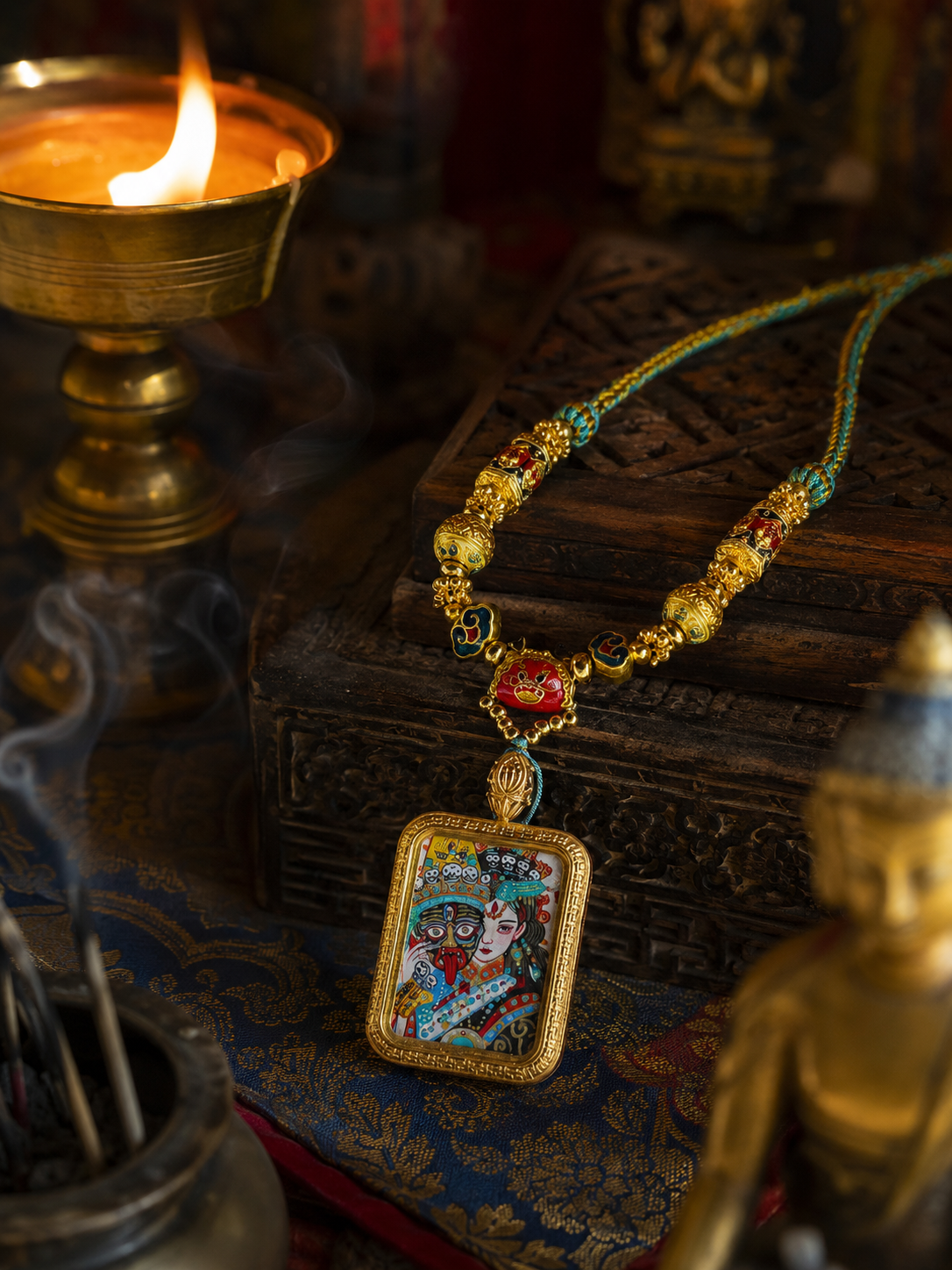 Zaki Lhamo pendant standing against a carved box, showing its colored painting and beaded necklace