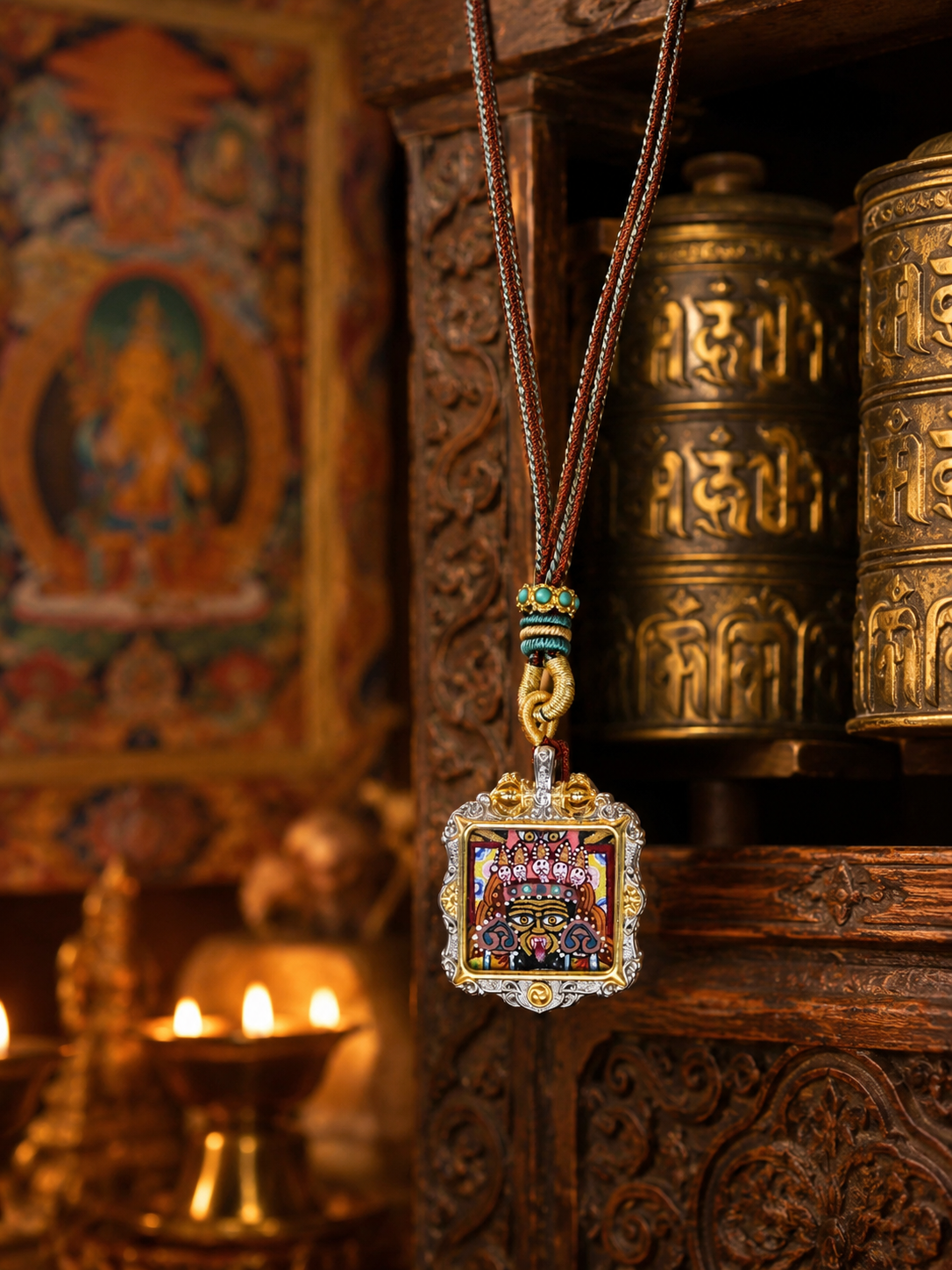 Zaki Lhamo square ghau pendant hanging beside carved wood and metal vessels