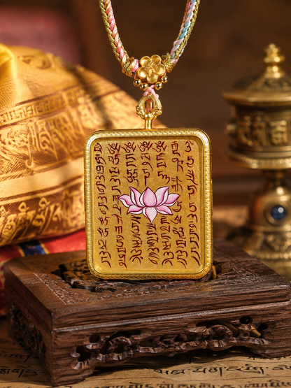Front view of the Lotus Sutra pendant, showing the pink flower and rows of painted script