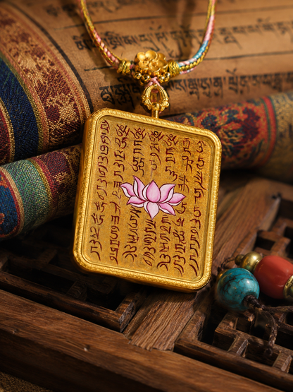 Lotus Sutra pendant resting against patterned fabric, with its braided necklace visible
