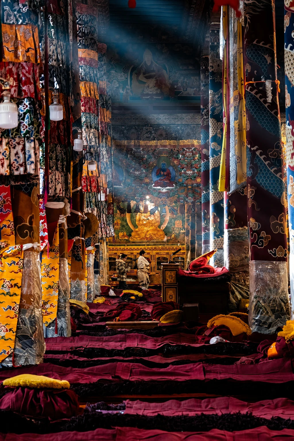 Painted columns and sacred images inside a Tibetan temple